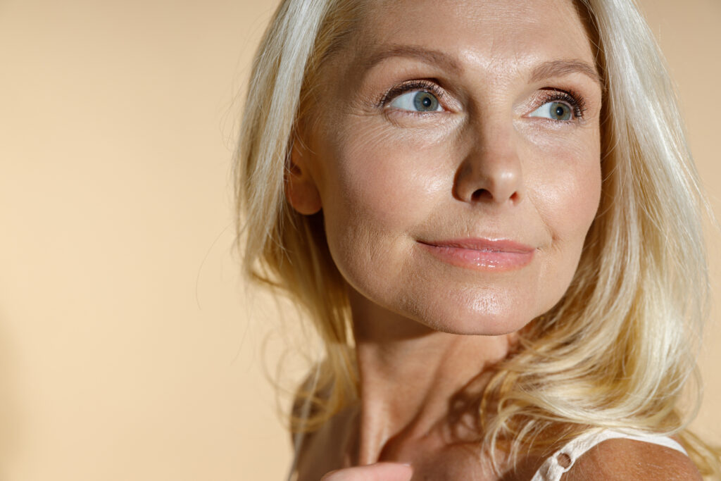 Woman with blonde hair looking to one side, showing her jawline and neck