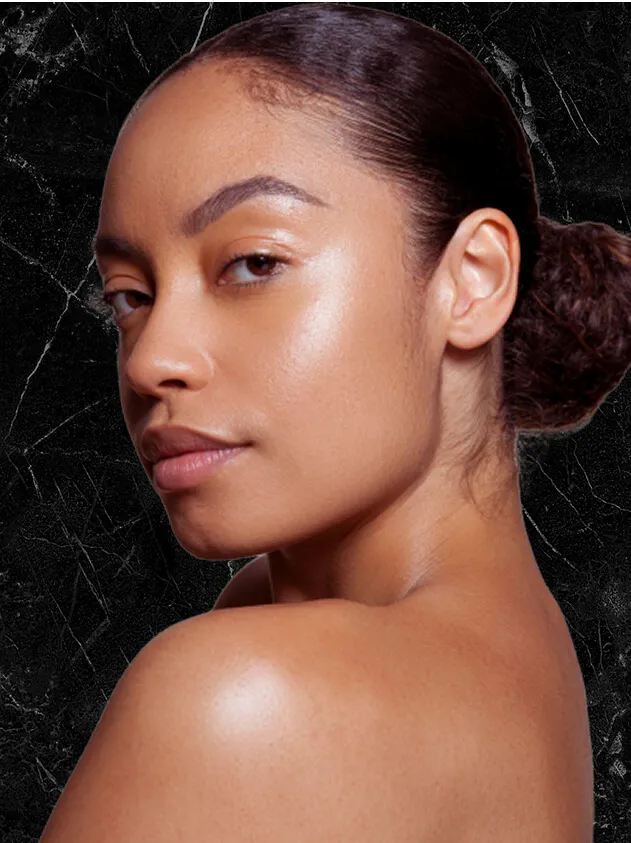 Woman looking over her shoulder with smooth, glowing skin