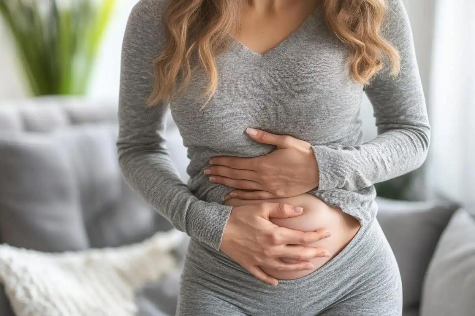 Hormonal Imbalance: Woman holding her lower abdomen, representing symptoms associated with hormonal imbalance.